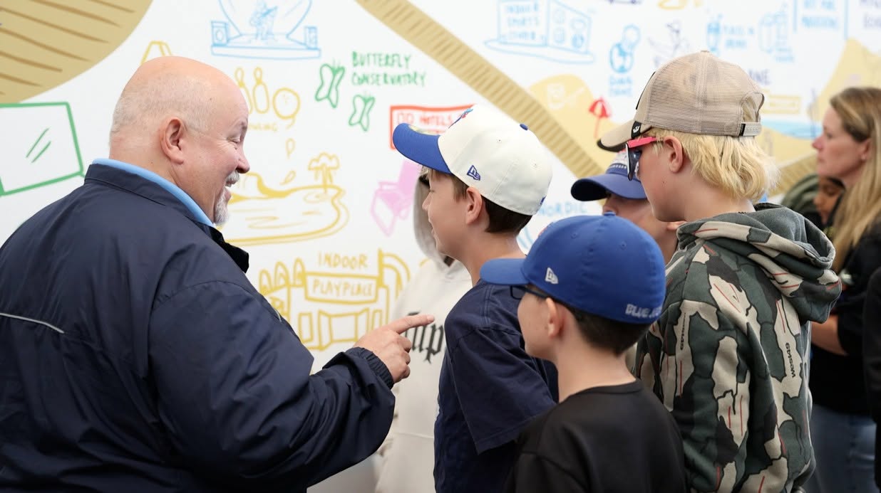 Brian Smith speaking with young residents at a community event